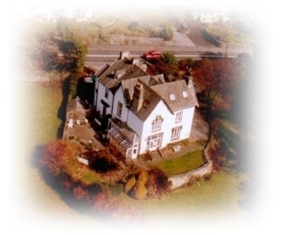 an aerial view of a large house in the water at Meadowbank in Ambleside