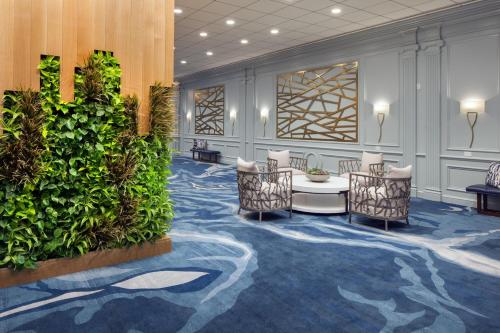 a lobby with chairs and a green wall at The Westin Oaks Houston at the Galleria in Houston
