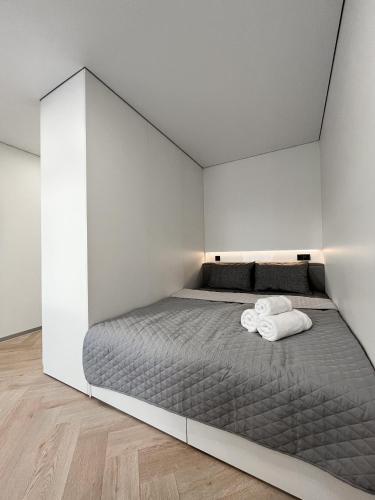 a bedroom with a bed with two towels on it at Апартаменти VIP з видом на Театр - Мережа HELEN in Poltava