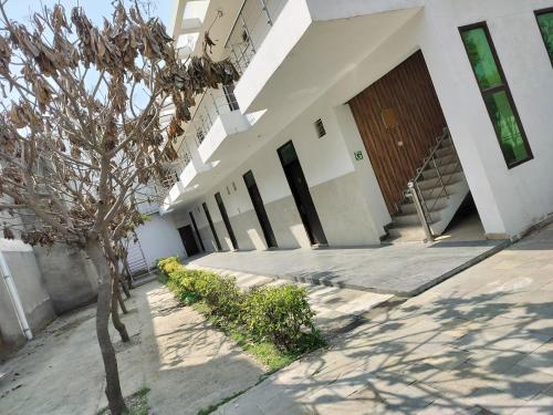 a building with a tree in front of it at Kingston banquet and event center in Kurukshetra