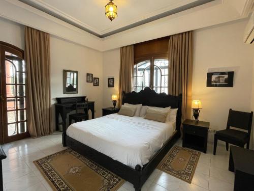 a bedroom with a bed and a desk and a piano at Dar Tahra in Casablanca