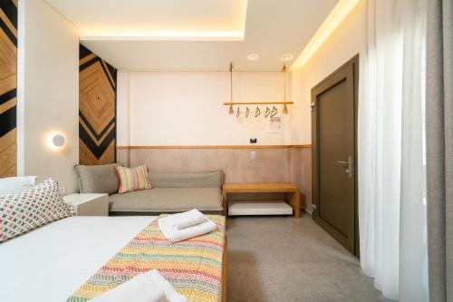 a small room with a bed and a couch at Reverie in Limenaria