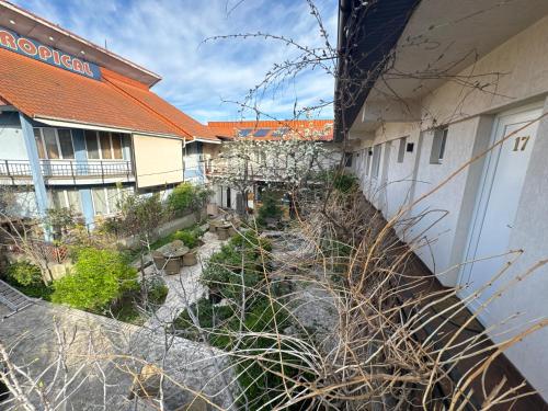 an outside view of a building with a garden at Pensiunea Drobeta in Drobeta-Turnu Severin
