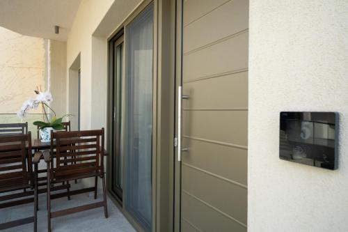 a sliding glass door in a room with a table at Reverie in Limenaria