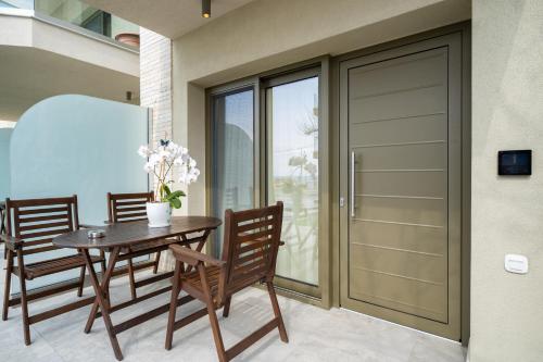 a dining room with a table and chairs and a sliding glass door at Reverie in Limenaria
