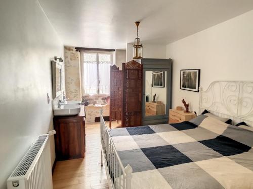 a bedroom with a bed and a sink in it at Cordeliers Dandelion in Sarlat-la-Canéda