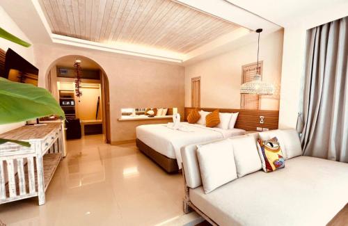 a hotel room with two beds and a couch at Amity Beach Resort in Lamai