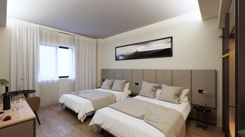 a hotel room with two beds and a window at Acca Sporting Milano - AA Hotels in Opera