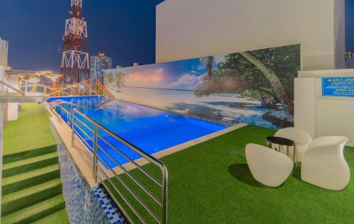 a swimming pool on the roof of a building with chairs at TND Hotel in Nha Trang