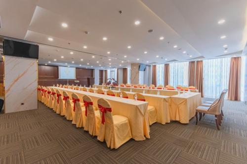 a conference room with rows of tables and chairs at TND Hotel in Nha Trang