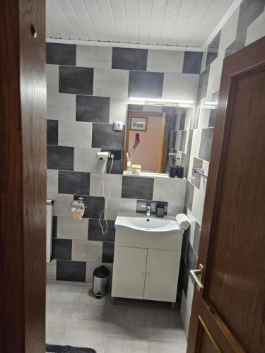 a bathroom with a sink and a mirror at Villa Szófia in Siófok