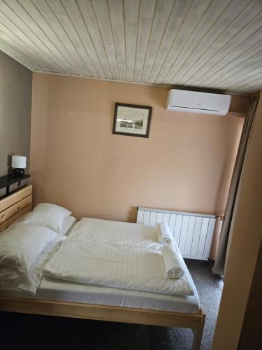 a bedroom with a bed with a ceiling at Villa Szófia in Siófok