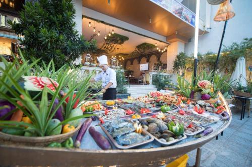 a chef standing in front of a buffet of food at TND Hotel in Nha Trang