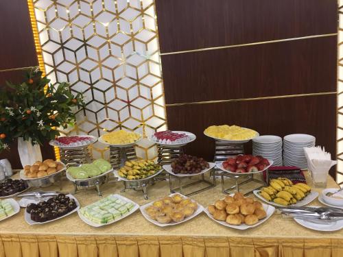 a buffet of food on a table with plates of food at TND Hotel in Nha Trang