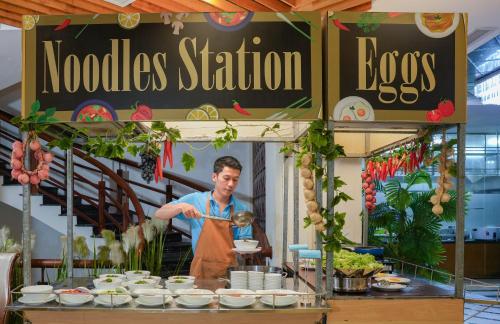 a man is preparing food in a food stand at TND Hotel in Nha Trang