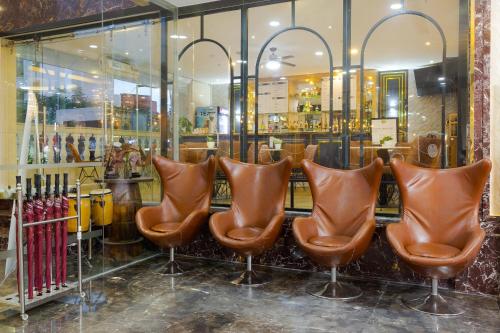 a row of brown leather chairs in front of a store at TND Hotel in Nha Trang