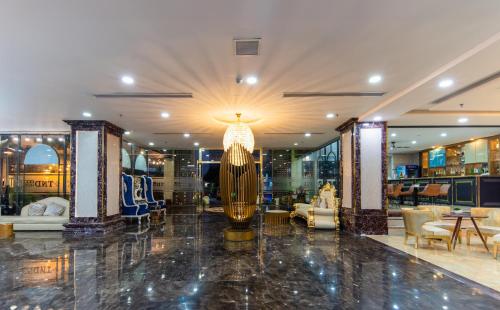 a store lobby with a large gold lamp in the middle at TND Hotel in Nha Trang