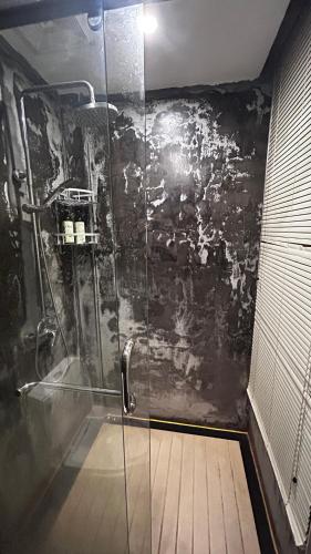 a bathroom with a shower with a glass door at Family Hotel Zhangjiajie in Zhangjiajie