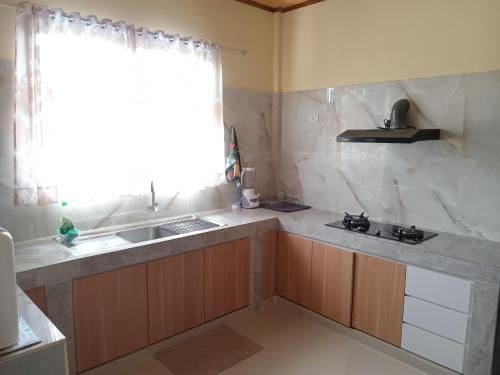a kitchen with a sink and a counter top at Alice Villa in Tuk Tuk