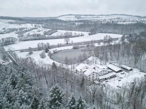 a house on a hill covered in snow at Kreuzberghof in Tiefenbach