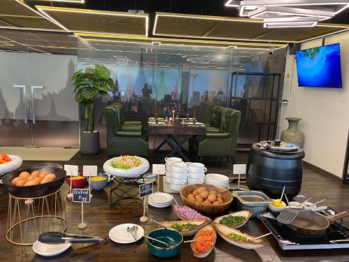 a table topped with bowls and plates of food at Citadines Sukhumvit 11 Bangkok in Bangkok