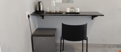 a black counter with a chair under a table at Abay Lodge in Durban