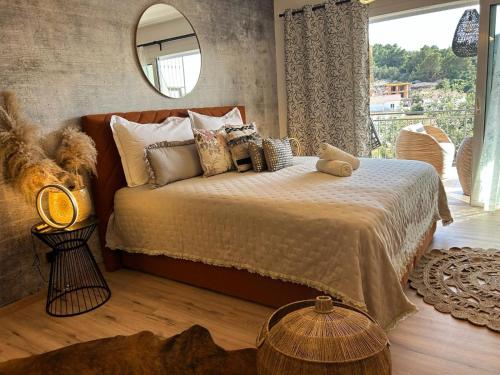 a bedroom with a bed with a mirror and a window at Villa Mili in Hvar