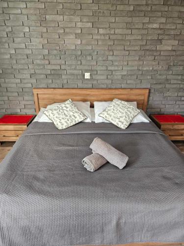 a bed with two pillows and two towels on it at Apartament Rabinówka in Maruszyna