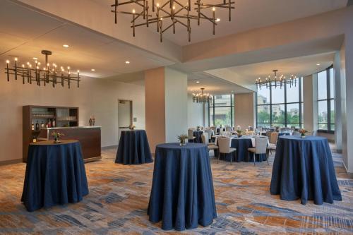 a banquet hall with tables and chairs and chandeliers at The Westin Indianapolis in Indianapolis