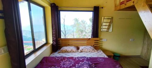 a small bedroom with a bed and a window at Ababeel Homestay, Hartola in Rāmgarh