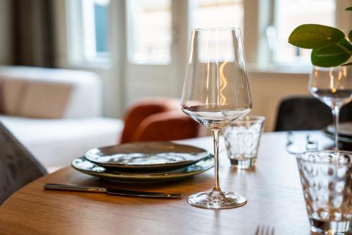 a glass of wine sitting on a wooden table at Luxe Appartement nabij centrum in Zwolle