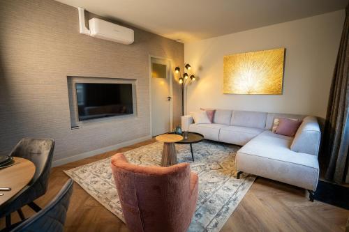 a living room with a couch and a table at Luxe Appartement nabij centrum in Zwolle