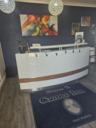 a counter in a room with a sign on the floor at Cameo Inn Motel in West Wyalong