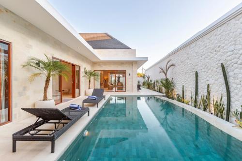 an image of a swimming pool in a house at The Clara Ville in Canggu