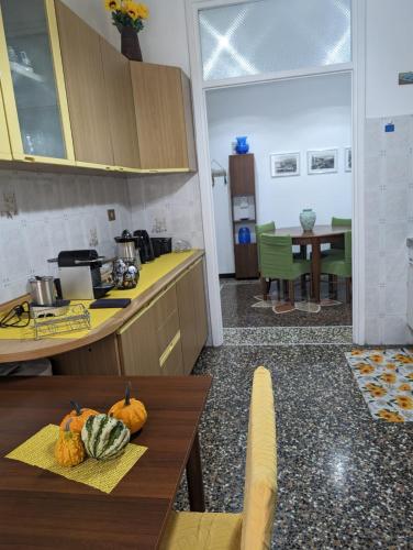 a kitchen with a counter and a table with pumpkins on it at CasaLeonardo in Genoa