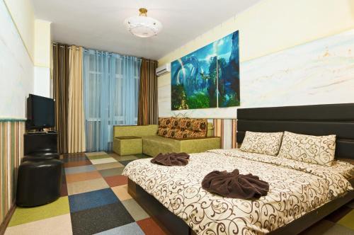 a bedroom with a large bed and a couch at Lukyanovsky in Kyiv