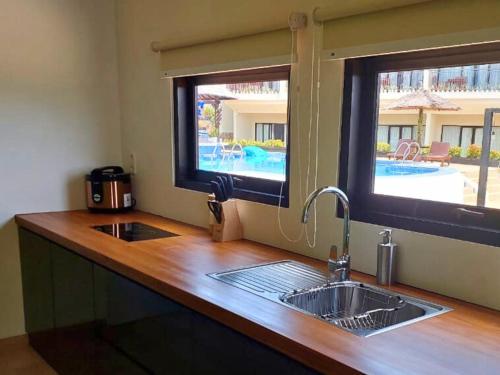 a kitchen counter with a sink and a window at The Happinezz Hills Hotel in Karimunjawa