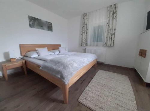 a bedroom with a large bed and a rug at Ferienhaus Urschitz in Eichberg Arnfels