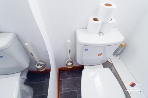a bathroom with a toilet and rolls of toilet paper at Stunning Flats in Handsworth Birmingham Close to ONE STOP Perry barr andAston Football club in Birmingham