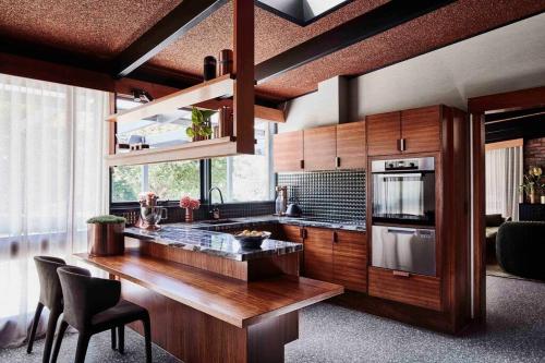 a kitchen with a wooden counter top and a stove at Sibbel House- Luxurious Mid-Century Modern Home, Yarra Valley in Healesville