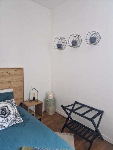 a bedroom with a bed and three spheres on the wall at Les Minimes in Issoudun