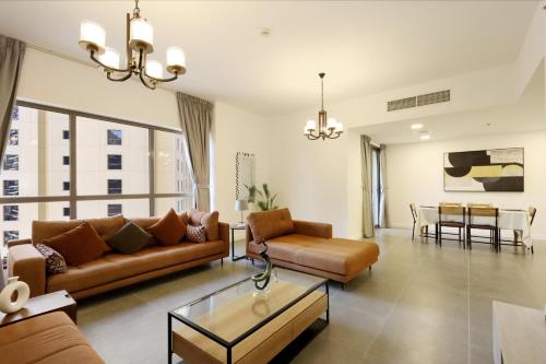 un soggiorno con divani e una sala da pranzo di Livbnb- Homely 3+1 in Heart of JBR, Close to Beach a Dubai