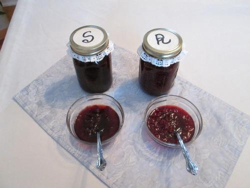 two jars of jam on a plate with spoons at Gîte Les Acres Tranquilles B&B in Port-Daniel