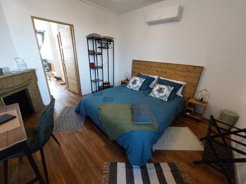 a bedroom with a bed with blue sheets and pillows at Les Minimes in Issoudun
