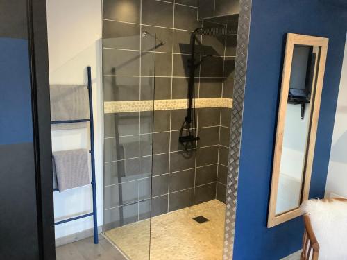 a shower with a glass door in a bathroom at Le Caux ´Sy in Senneville-sur-Fécamp