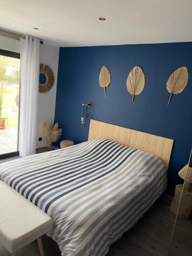 a bedroom with a bed with umbrellas on the wall at Le Caux ´Sy in Senneville-sur-Fécamp