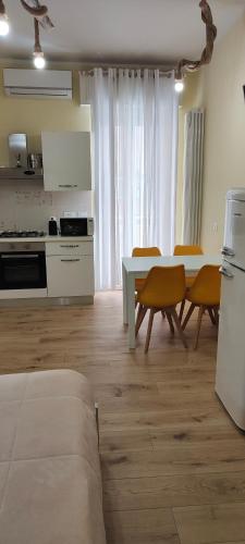 a kitchen and dining room with a table and chairs at The Sorabellas in Gaeta