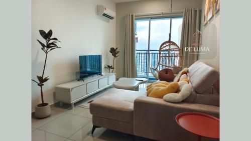 a living room with a couch and a television at De Luma-Metropol 3Bedrooms in Bukit Mertajam