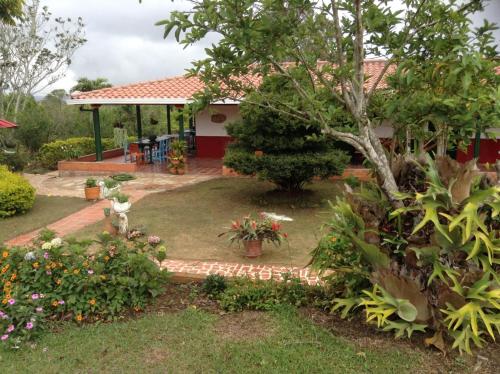 a garden in front of a house at Villa Liliana Lodge Mesa de los Santos in Los Santos