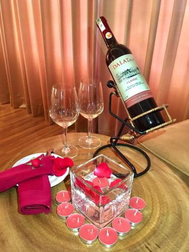 a bottle of wine on a table with two wine glasses at TND Hotel in Nha Trang